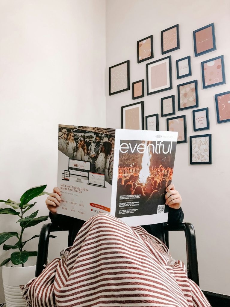 person-sitting-on-armchair-reading-magazine-efcyfi7ugay